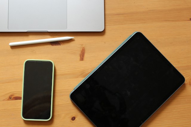 Laptop, Cellphone, and a Pen on a Table